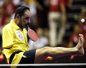 Table Tennis player Ibrahim Hamato of Egypt serves with his foot during an exhibition match at the 2016 World Team Table Tennis Championships at Malawati Stadium in Shah Alam on March 6, 2016. / AFP / MANAN VATSYAYANA / The erroneous mention[s] appearing in the metadata of this photo by MANAN VATSYAYANA has been modified in AFP systems in the following manner: [Hamato] instead of [Hamadtou]. Please immediately remove the erroneous mention[s] from all your online services and delete it (them) from your servers. If you have been authorized by AFP to distribute it (them) to third parties, please ensure that the same actions are carried out by them. Failure to promptly comply with these instructions will entail liability on your part for any continued or post notification usage. Therefore we thank you very much for all your attention and prompt action. We are sorry for the inconvenience this notification may cause and remain at your disposal for any further information you may require.